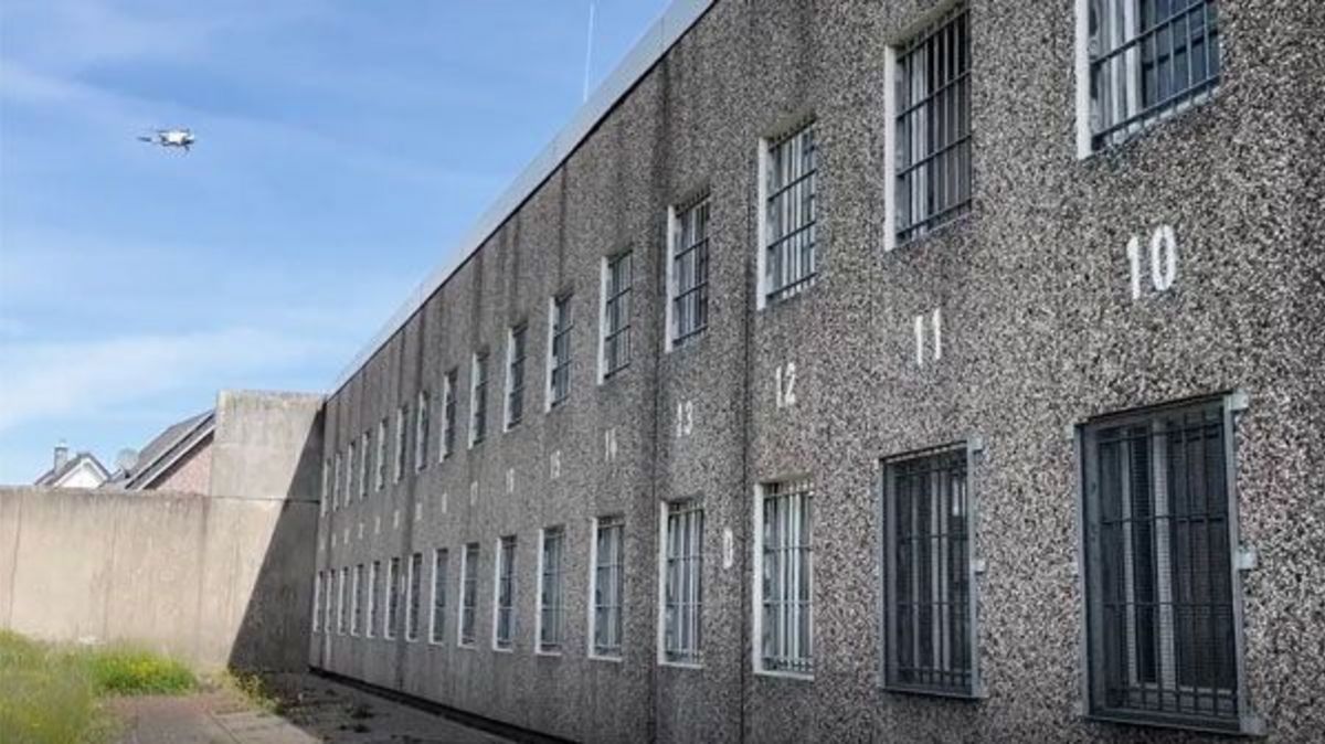 Eine Drohne fliegt vor einem Gebäude der JVA.
